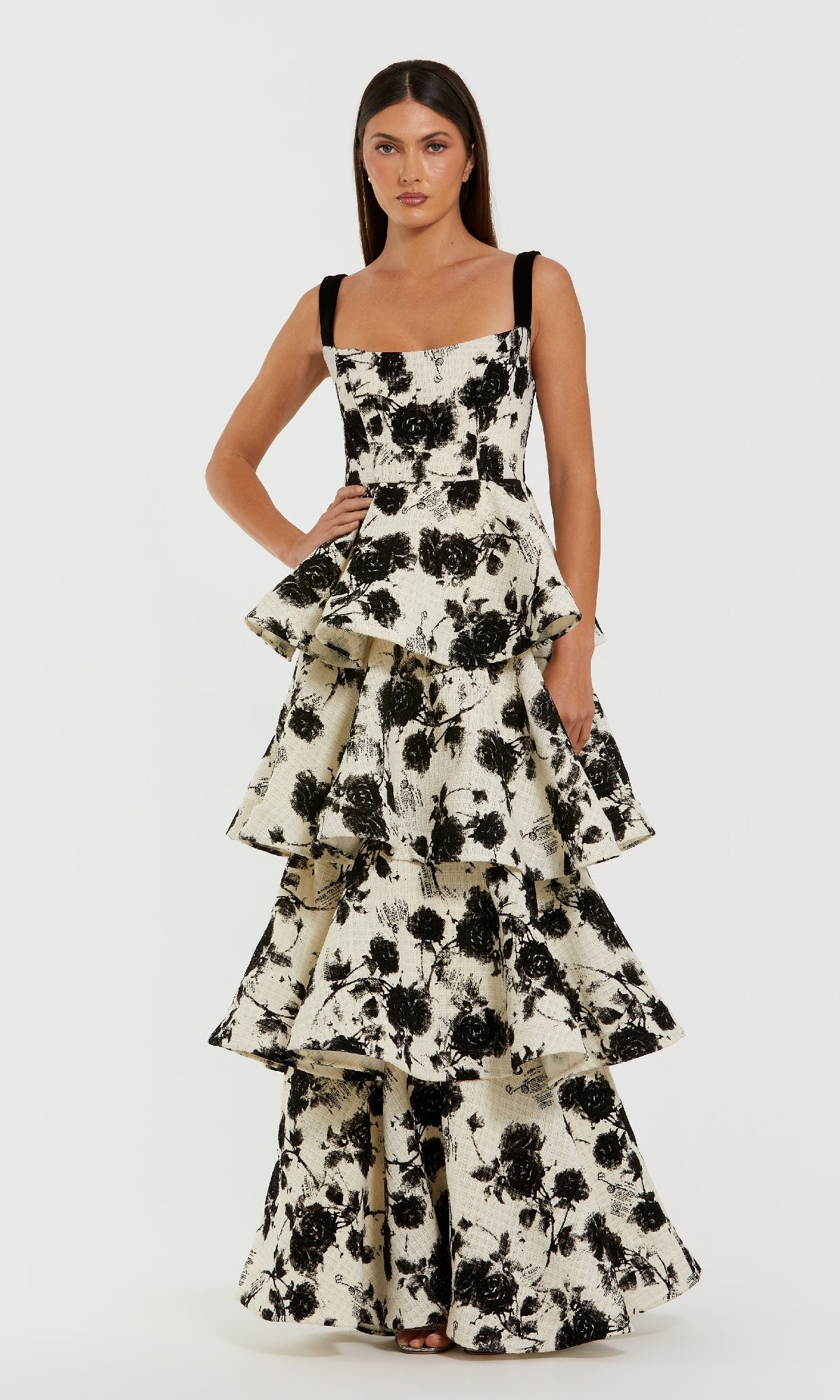 Woman wearing a black and white floral dress on a white background